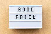 Light box with word good price on wood background