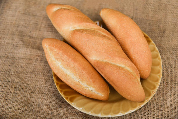 istock bread and buns assortment / Fresh Bakery bread various types on plate with sack background / homemade breakfast food 1150418124