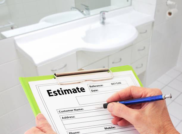 Hand Writing an Estimate for Bathroom Renovation stock photo