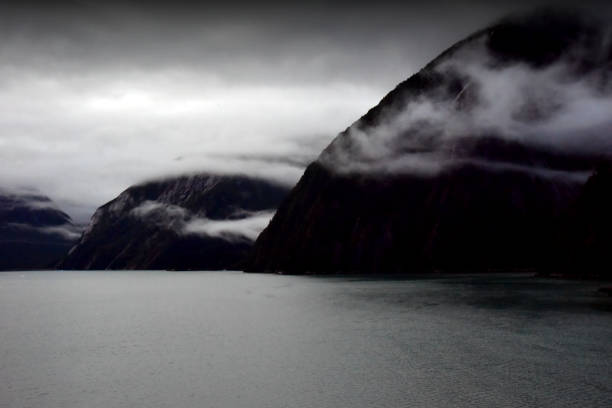 Alaska - Clouds rolling off mountains at the coast.