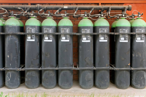 Green argon gas cylinders with pressure gauges Bundle of green argon gas cylinders with pressure gauges argon stock pictures, royalty-free photos & images