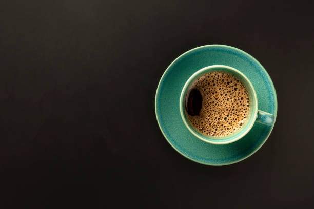 istock A cup of coffee on a black background, shot from above with copy space 1150426258