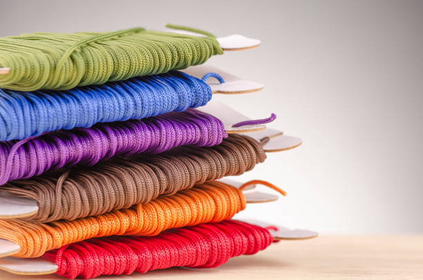 istock colorful stacking cotton yarn wool over beautiful reverberation gradient background. 1150426933
