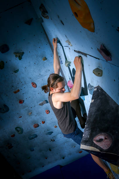 istock Teenage Boy Training Climbing On Indoor Climbing Wall 1150427500