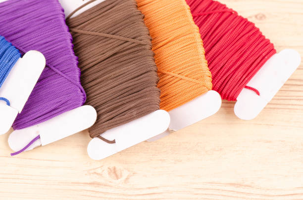 istock colorful stacking cotton yarn wool on wooden background. copy space for text 1150427573