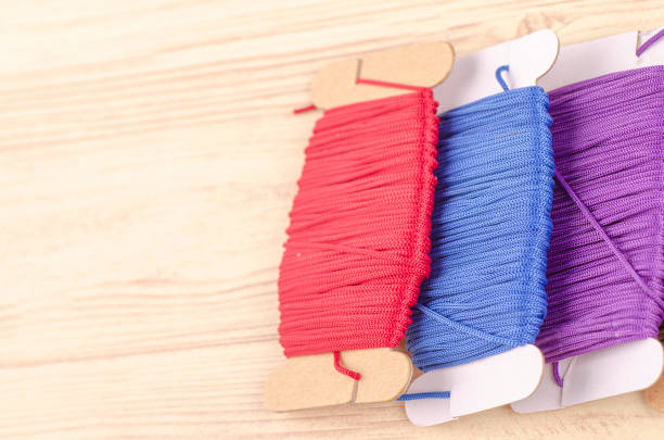 istock colorful stacking cotton yarn wool on wooden background. copy space for text 1150427583