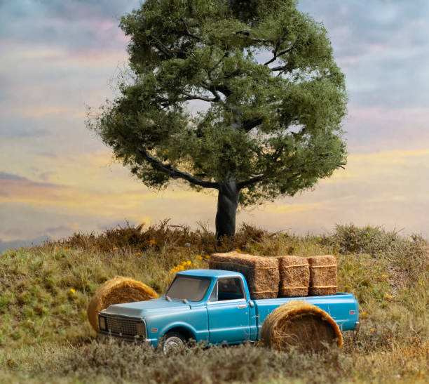 istock Dusty Blue Truck Under Oak  Tree and Barn Hay 1150428685