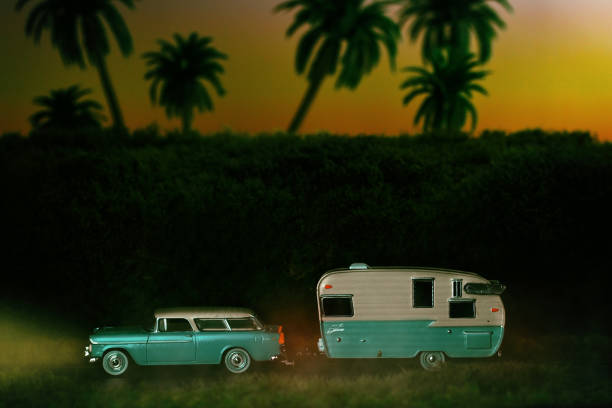Vintage Car with Camper Driving at Dusk