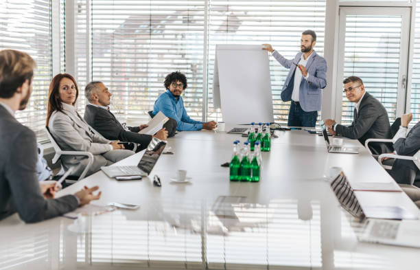 istock Male CEO communicating with his colleagues during a presentation in a board room. 1150429678
