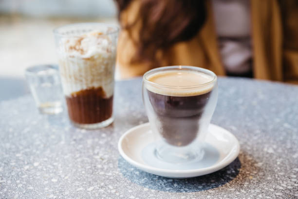 istock Frothy Nitro Cold Brew Coffee in drinking glass on granite top table with blur background. 1150433574