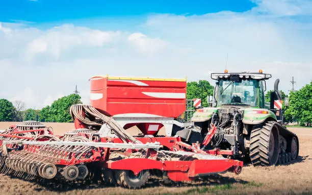 Photo of tractor with drills on the field in Kiev region, Ukraine