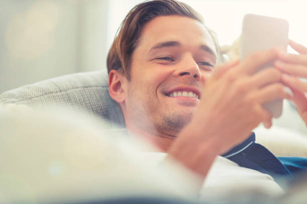 istock Man lying on the sofa with a mobile phone. 1150434179