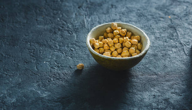 istock Bowl chickpea close up on dark stone background with copy space 1150435195