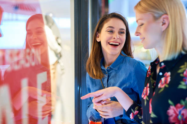 istock Happy girl looking at window display 1150436482
