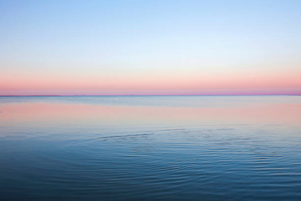 meereswelle bei sonnenuntergang - horizont über wasser stock-fotos und bilder