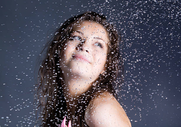 istock young brunette woman with water droplets 115043843