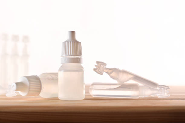 istock Plastic bottle and pipettes with eye medication on wooden table 1150440952