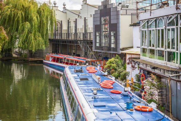 Canal tour boat waterbus at Camden market in London Canal tour boat waterbus at Camden market in London, UK camden stables market stock pictures, royalty-free photos & images