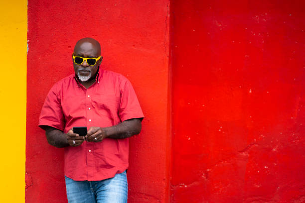 istock African man using phone on colorful background 1150447631