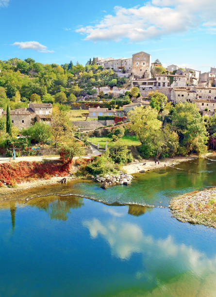 Balazuc in the Rhône-Alpes region. The picturesque village is located on a rock above the river Ardèche. waist deep in water stock pictures, royalty-free photos & images