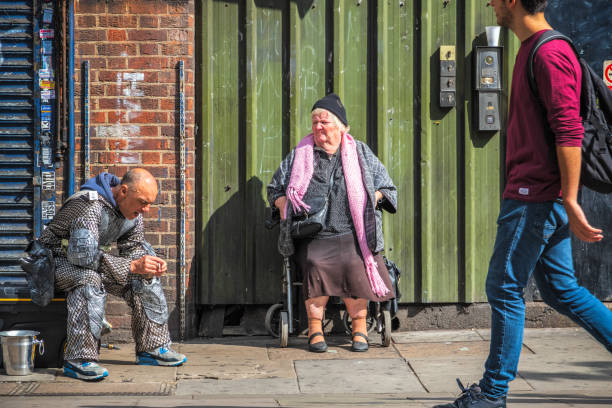 A woman in a wheelchair around Camden street market, London London, UK - 12 September, 2018 - A woman in a wheelchair around Camden street market camden lock stock pictures, royalty-free photos & images