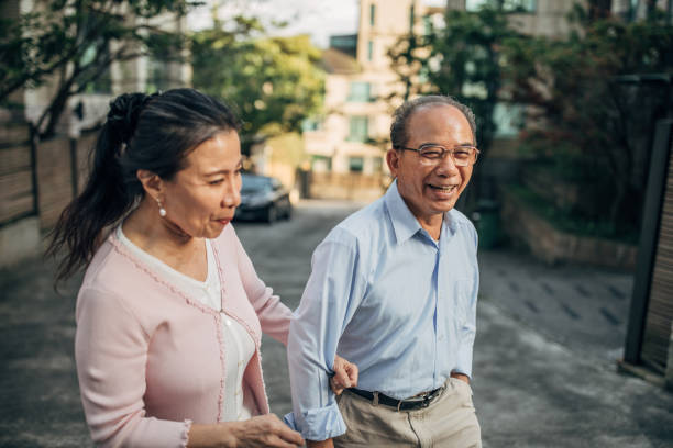 married senior couple taking a walk on the street - active seniors enjoyment driveway vitality imagens e fotografias de stock