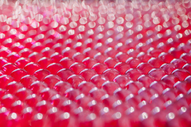 soft focus on a group of lined hydrogel balls in fuchsia color