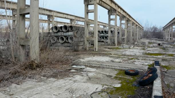 istock Old abandoned factory with concrete pipes and structures 1150453917
