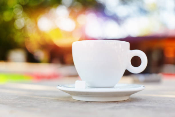 istock Morning coffe or tea in a white cup with beautiful glowing bokeh at the background 1150455129