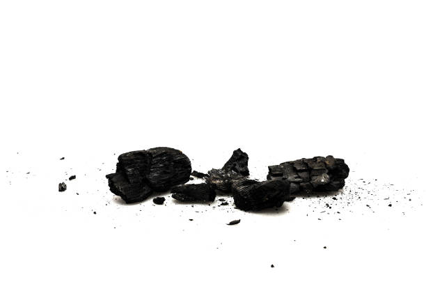 istock Black burnt firewood with ash on white surface 1150455913