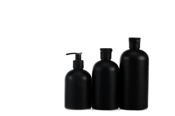 istock Black cosmetic bottles with spray and caps isolated on white 1150456654