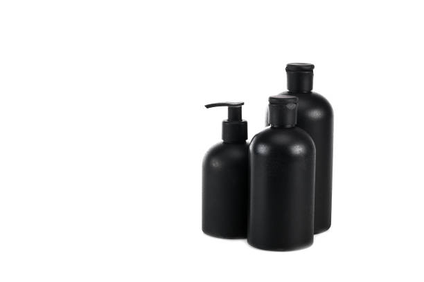 istock Black cosmetic bottles with spray and caps isolated on white 1150456657