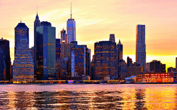 istock warm sunset on manhattan modern architecture skyline with moody reflections on Hudson river, Manhattan New York city 1150456972