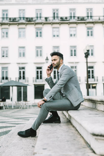 istock Young businessman using smart phone on steps in city 1150458542