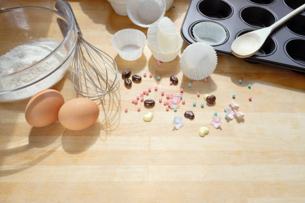 istock baking cupcakes, tools and ingredients on a wooden kitchen board, copy space 1150458932