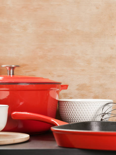 istock Cookware set: Red enameled cast iron pot, saucepan and bowls 1150459013