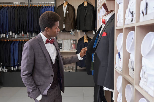 istock Client standing near mannequin and choosing jacket. 1150459279