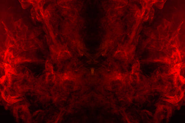 smoke of different orange and red colors in the form of horror in the shape of the head, face and eye with wings on a black isolated background. soul and ghost in mystical symbol - toxic substance smoke abstract green imagens e fotografias de stock