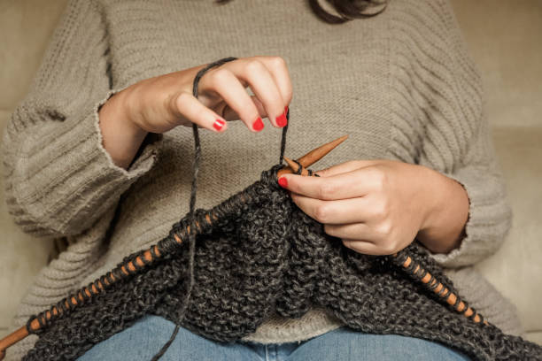 istock knitting dark gray wool with wooden needles 1150462047