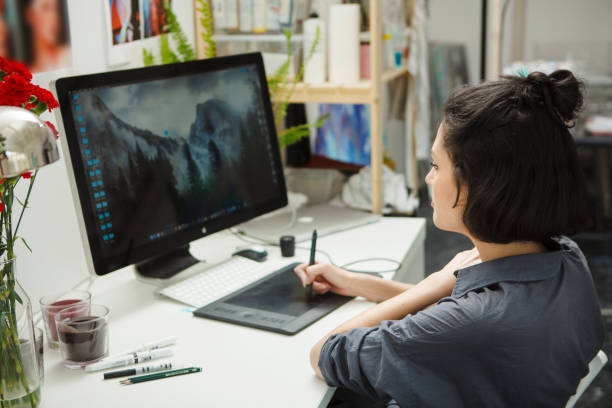 istock Woman works at computer, analysis and draws in freehand 1150462089