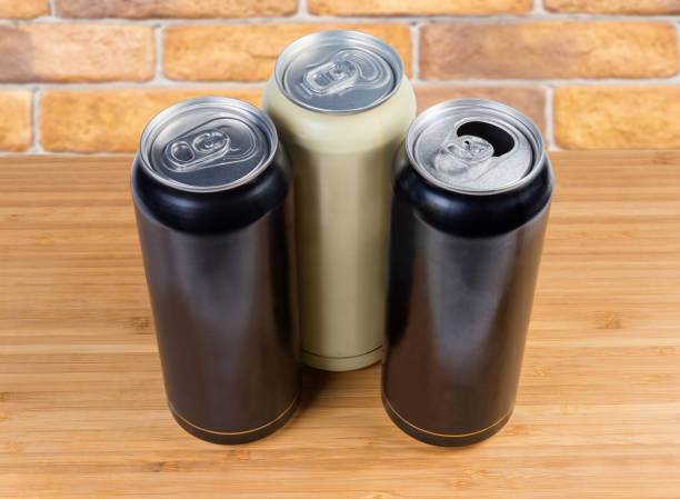 istock Sealed and open beverage cans close-up on wooden surface 1150462102