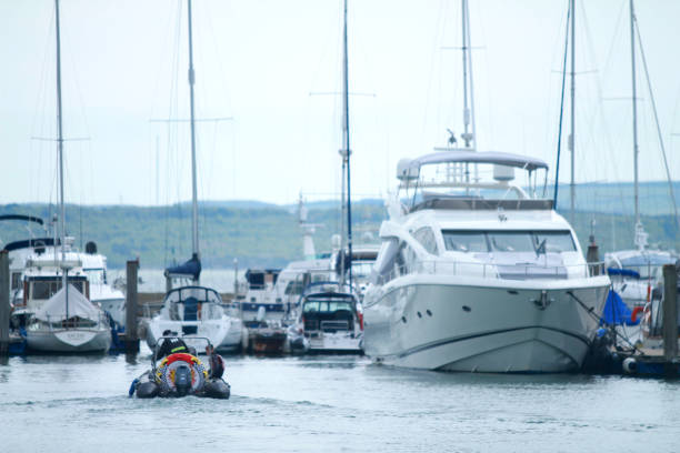 istock rib passing yacht in Lymington harbour 1150465069