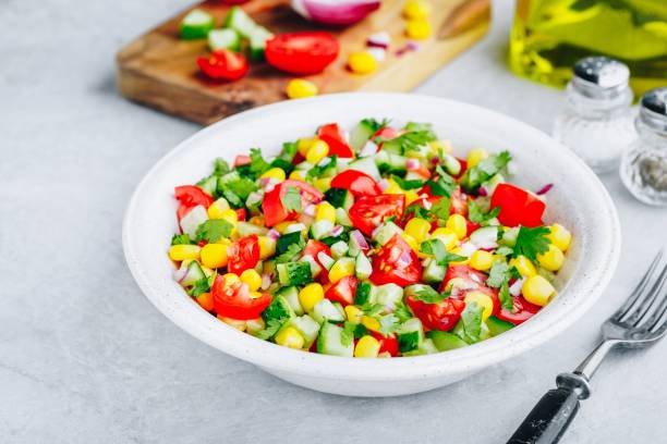 istock Fresh summer corn salad bowl with tomatoes, cucumbers, red onions and parsley. 1150468154