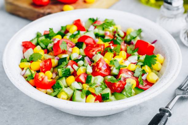 istock Fresh summer corn salad bowl with tomatoes, cucumbers, red onions and parsley. 1150468218