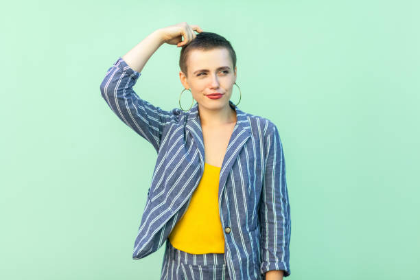 portrait of query or confused handsome beautiful short hair young stylish woman in casual striped suit standing scratching her head and thinking. - pensive question mark teenager adversity imagens e fotografias de stock