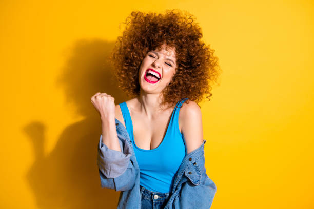 istock Portrait of her she nice cute lovely charming crazy glamorous attractive cheerful cheery overjoyed wavy-haired girl rejoicing having fun party isolated over bright vivid shine yellow background 1150469708