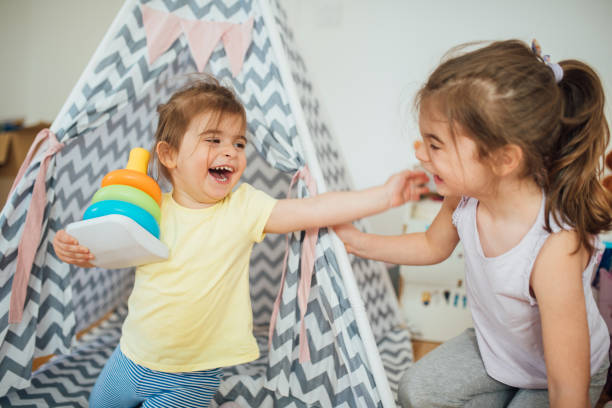 istock Girls playing and smiling at home 1150470146