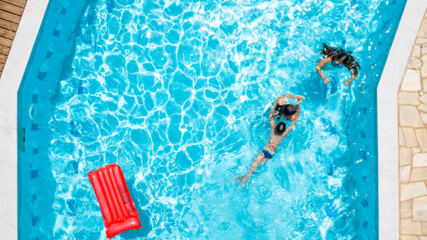 istock Directly above three children playing in the swimming pool 1150471607