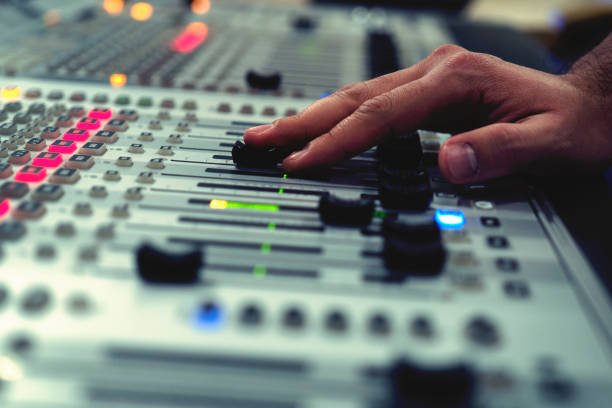 istock Professional audio mixing console with faders and adjusting knobs - radio / TV broadcasting 1150471880
