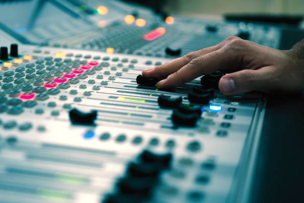 istock Professional audio mixing console with faders and adjusting knobs - radio / TV broadcasting 1150473428